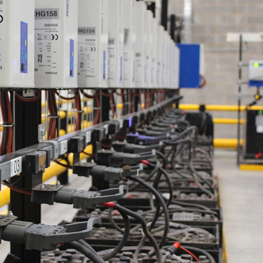 A forklift truck battery room full of lead acid batteries on charge
