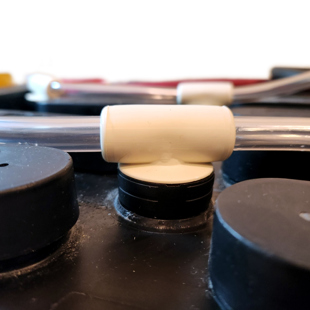 A Flame Arrested Water Injector System installed on a lead acid battery